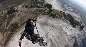 Turkish paraglider flies with motorcycle over Pamukkale